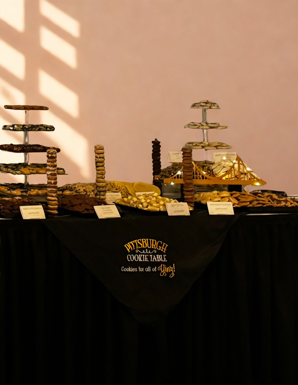 Pittsburgh cookie table with tiered displays and bridge centerpiece