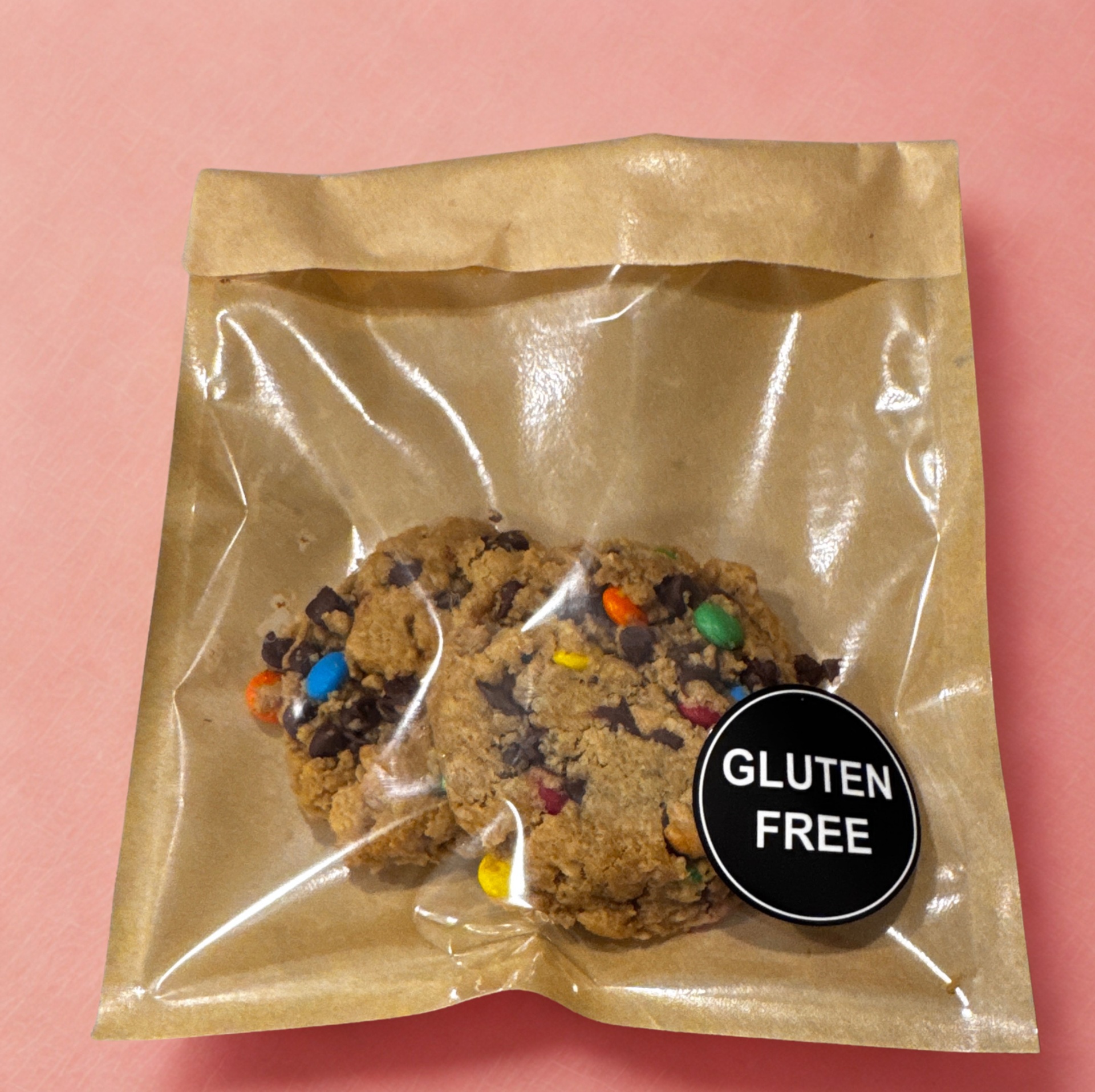 Gluten-free monster cookies with chocolate chips and M&Ms in kraft bag